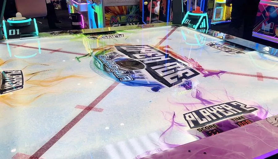 Arcade game with colorful lights and branding on a table